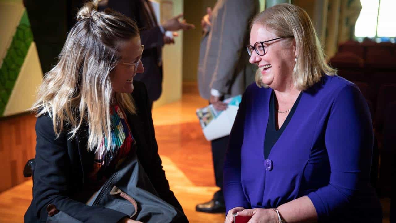 two women smiling two women smiling