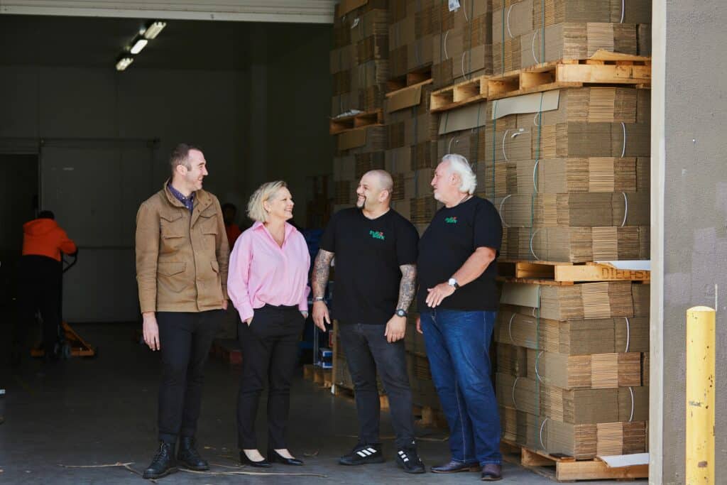 Tyron Bravo, Corinne Proske, Simon Fenech and Rob Brown in the loading bay at Fruit2Work