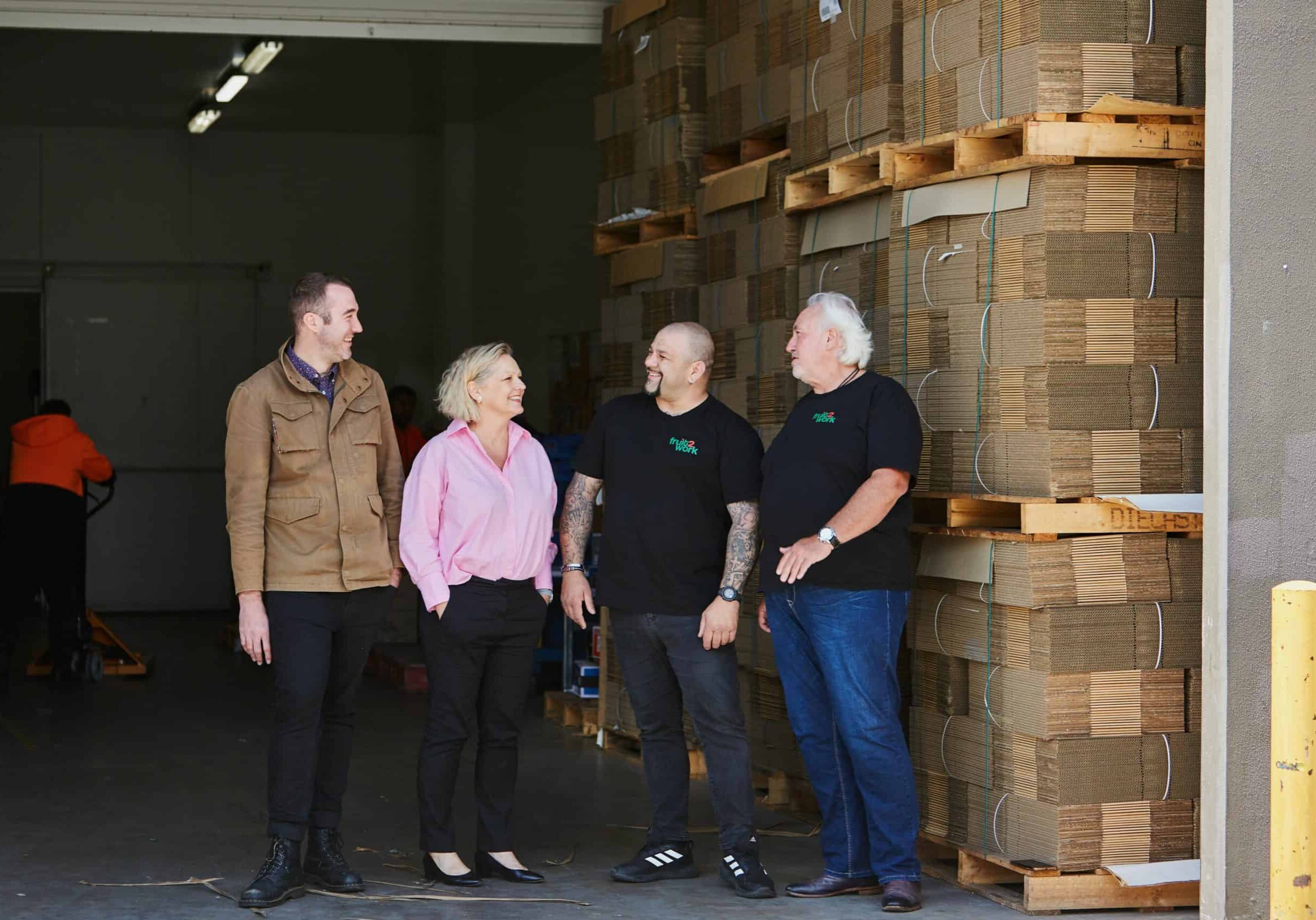 Tyron Bravo, Corinne Proske, Simon Fenech and Rob Brown in the loading bay at Fruit2Work